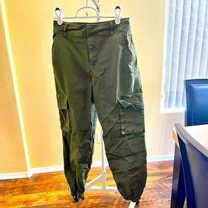 Green cargo pants cinched on the bottom with pockets